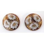 A pair of faux tortoiseshell / celluloid clip earrings with floral decoration.