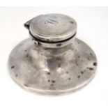A silver inkwell of capstan form engraved March 1916 and hallmarked Birmingham 1913.