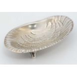 Tiffany & Co : A Sterling silver clam shell formed dish on three feet.