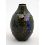 A Royal Doulton '' Titanian '' ovoid vase decorated with a bird of paradise with gilt highlights on
