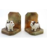 A pair of Art Deco bookends formed as alabaster and cold painted spelter wire aired terriers.