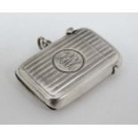 A silver vesta case with engine turned banded decoration.