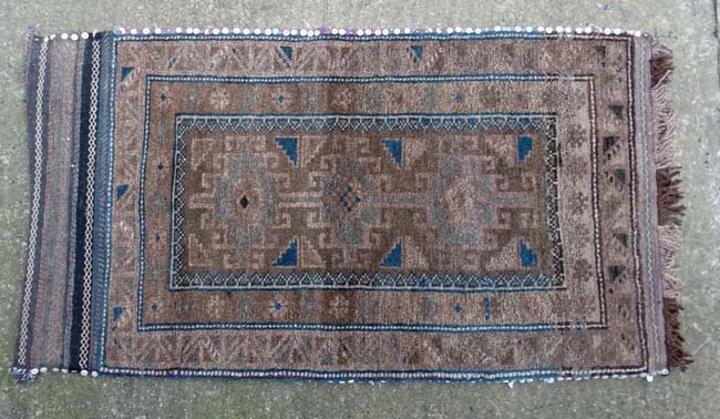 Rug / Carpet : a hand made woollen rug in buffs,