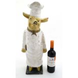 A shop display model of a polychrome painted cast iron model of a of a comical pig in chefs whites