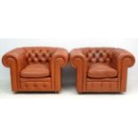 A pair of late 20thC leather button back Chesterfield single chairs.