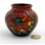 A small Moorcroft '' Anemone '' pattern flambe vase,