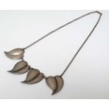A white metal and silver necklace of chain form with honesty leaf / stylised heart shaped drops.
