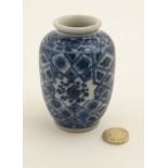 A small Chinese blue and white vase, with floral decoration to the star shape cartouches,