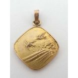 A gilt metal pendant with Japanese Aesthetic movement decoration depicting birds sea and waves.