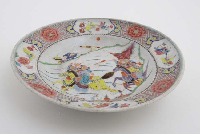 A Chinese bowl decorated in polychrome enamels with warring figures on horse back to well , - Image 2 of 3