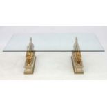 Mid century / Hollywood Regency : a plate glass coffee table with two pairs of winged Sphinx