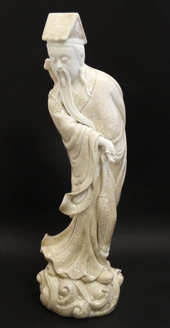 A Chinese Blanc De Chine crackle glaze figure of a sage holding a parasol with a sword upon his - Image 6 of 8