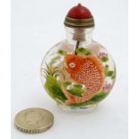 A Chinese rock crystal snuff bottle? with hand painted image of carp fish amongst with four