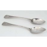 A pair of Geo III silver teaspoons with bright cut decoration.