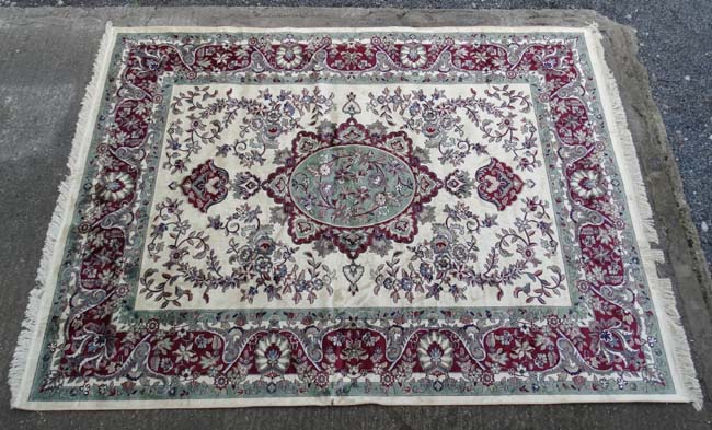 Carpet / Rug : a Tabriz machine made beige ground carpet, with sage green ground central medallion,