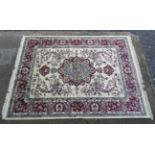 Carpet / Rug : a Tabriz machine made beige ground carpet, with sage green ground central medallion,