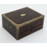 A burrwood Campaign box with brass edges and corners and drawer under.