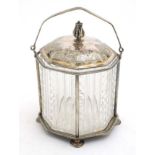 A cut glass biscuit barrel of octagonal form with silver plate stand and cover and swing over