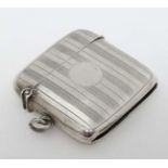 A silver vesta case with engine turned banded decoration.