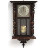 Clock : an early 20 thC Walnut cased 8 day Wall clock with sprung movement striking on a gong,