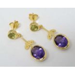 A pair of silver gilt drop earrings set with amethyst and peridot.