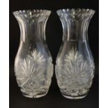 A pair of lead crystal cut glass vases with flared rims and star cut detail under.