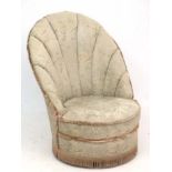 Art Deco : A scallop shell upholstered Nursing chair with circular base with four castors ,