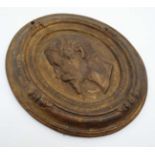 A 19thC cast iron oval plaque with painted gilt decoration having figure head in profile to centre.