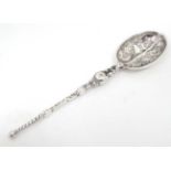 A silver teaspoon formed as a miniature anointing spoon,