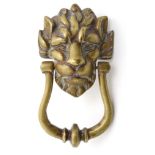 An early - mid 20thC cast brass door knocker in the form of a lions head. approx 4 1/2" wide.