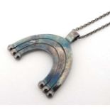 Scandinavian ( Finland ) jewellery : A mid 20thC silver pendant of stylized rainbow like form.