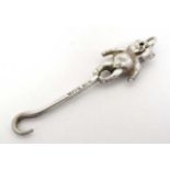 A miniature silver button hook surmounted by a bear Hallmarked Birmingham 1905 maker Adie Lovekin