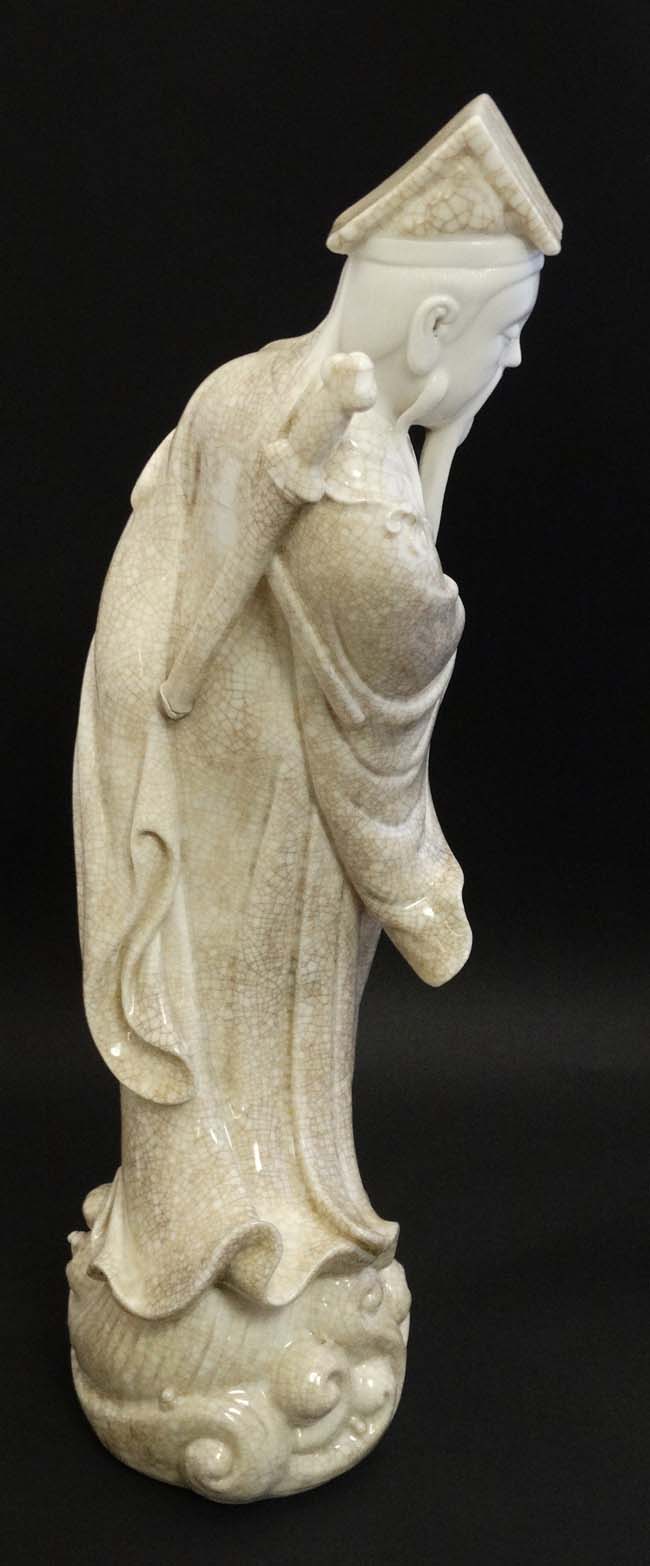 A Chinese Blanc De Chine crackle glaze figure of a sage holding a parasol with a sword upon his - Image 3 of 8
