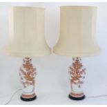 A pair of Chinese table lamps with silk shades.