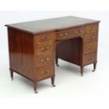 An Edwardian breakfront cross banded and strung inlaid pedestal mahogany desk 44" wide x 23 1/4"