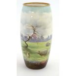 An early 20thC Royal Doulton ovoid vase with hand painted decoration featuring sheep in a