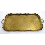 A large late 19thC Scottish Arts and Crafts brass 2-handled tray with punch work and folded