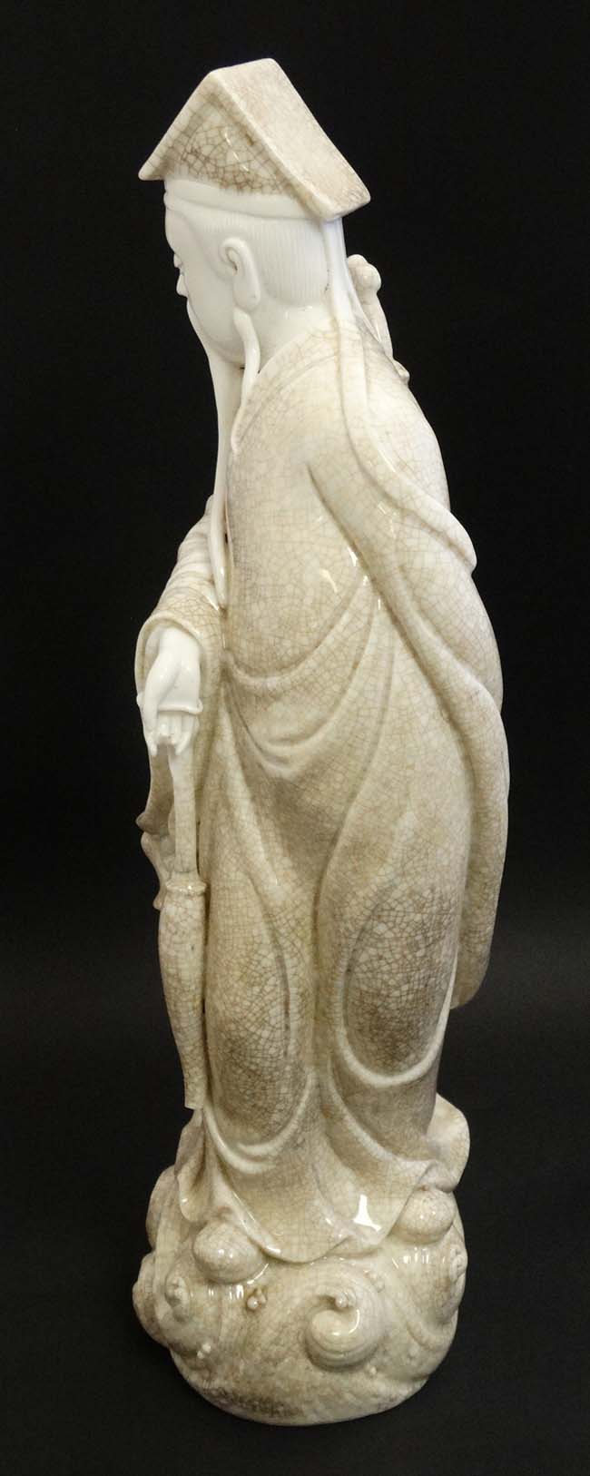 A Chinese Blanc De Chine crackle glaze figure of a sage holding a parasol with a sword upon his - Image 5 of 8