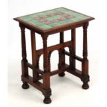 A late 19thc Aesthetic Movement / Arts and Crafts occasional table with tile top having tube lined