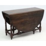 A c.1900 peg jointed oak gate leg table with bobbin turned stretchers and legs etc.