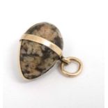 A pendant formed as an agate hardstone egg within a gilt metal mount.