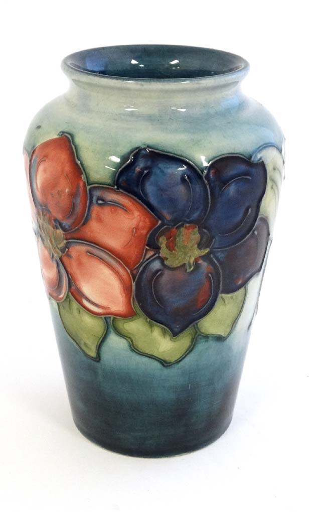 A mid 20thC Moorcroft '' Clematis '' pattern vase on a pale blue ground with tube lined decoration, - Image 4 of 4