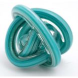 A late 20thC Art glass paperweight of turquoise knot form.