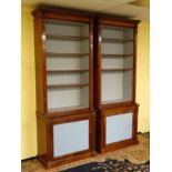 A pair of early 19thC and later open mahogany bookcases with original panels ( now removed from the