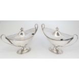 An 18thC pair of Old Sheffield Plate sauce tureens in the Adams style of classical boat shape with
