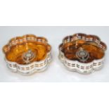 A pair of silver plated bottle coasters with faux tortoiseshell bases and piquet style decoration.