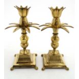 A pair of mid century / Hollywood Regency : A pair of brass candlesticks formed as pineapples upon