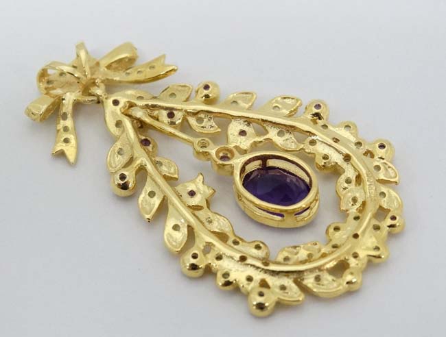 A silver gilt pendant set with amethysts and peridot. Marked 'Sterling' . - Image 2 of 4