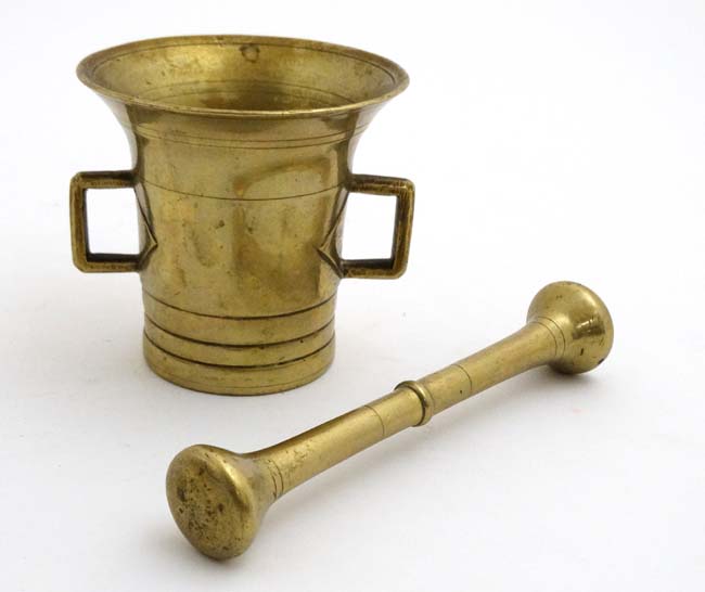 A 20thC brass two handled brass mortar and pestle.