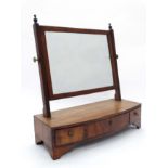 A late Regency mahogany bow front toilet mirror with 3 drawers.